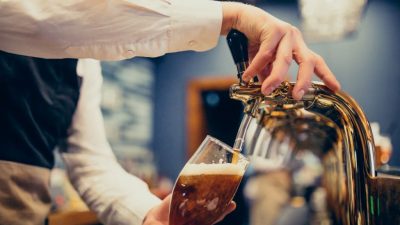 ahl male bartender pouring beer pub