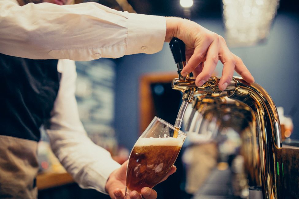 ahl male bartender pouring beer pub