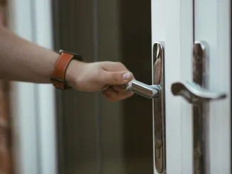 ahl closeup shot person holding door knob opening door